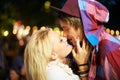 Couple, kiss and outdoor for festival, event and happy for love with romance in night at party. Woman, man and together Royalty Free Stock Photo