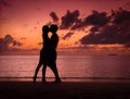 Couple Kissing on a Beach at Sunset