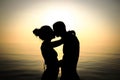 Couple kissing at the beach at sunset Royalty Free Stock Photo