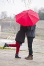 Couple kissing behind a red umbrela Royalty Free Stock Photo