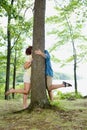 Couple kissing behind a tree Royalty Free Stock Photo