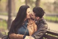 Couple kissing at the bench at alley.