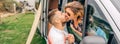 Couple kissing through the camper van window during a trip Royalty Free Stock Photo