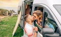 Couple kissing through the camper van window during a trip Royalty Free Stock Photo