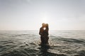 Couple kissing in middle of the sea