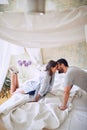 Couple kissing  in the morning while making the bed. bedroom, morning,  togetherness, romance concept Royalty Free Stock Photo
