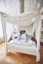 Couple kissing in the morning while making bed.  fresh, morning, couple, togetherness, concept Royalty Free Stock Photo