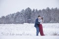 Couple kissing outdoors in winter snow