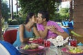 Couple Kissing Over Meal At Outdoor Table Royalty Free Stock Photo