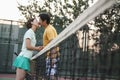 Couple kissing over the tennis net Royalty Free Stock Photo