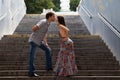 Couple kissing on stairs in a tunnel