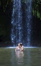 Couple kissing under a beautiful tropical waterfall Royalty Free Stock Photo