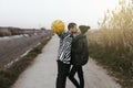 Couple kissing with a yellow basketball in countryside