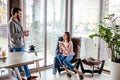 Couple in kitchen spending time together with cup of coffee and smartphone Royalty Free Stock Photo