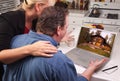 Couple In Kitchen Using Laptop - Cabin Royalty Free Stock Photo