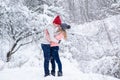 Couple in knitted hats going to kiss