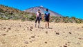 Couple on La Canada de los Guancheros dry desert plain with view on volcano Pico del Teide, Mount Teide National Park, Tenerife Royalty Free Stock Photo