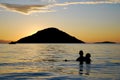 A couple in Lake Malawi at sunset Royalty Free Stock Photo