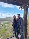 Couple of Latin adult man and woman enjoy the mountainous view of vineyards from a viewpoint you can see the land planted with vin