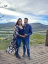 Couple of Latin adult man and woman enjoy the mountainous view of vineyards from a viewpoint you can see the land planted with vin