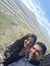 Couple of Latin adult man and woman enjoy the mountainous view of vineyards from a viewpoint you can see the land planted with vin