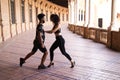 Couple of latin and bachata dancers dancing in a square. They are a young and handsome man and a beautiful woman. Dance concept Royalty Free Stock Photo