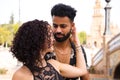 Couple of latin and bachata dancers dancing in a square. They are a young and handsome man and a beautiful woman. Dance concept Royalty Free Stock Photo