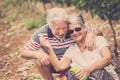 Couple laugh in happines together forever playing with soap bubbles in the country yard outdoor leisure activity. stay young Royalty Free Stock Photo