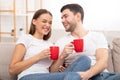 Couple Laughing Having Morning Coffee Sitting On Couch At Home Royalty Free Stock Photo