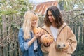 Couple of laughing teenagers with halloween pumpkins having fun Royalty Free Stock Photo