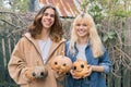 Couple of laughing teenagers with halloween pumpkins having fun Royalty Free Stock Photo