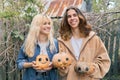 Couple of laughing teenagers with halloween pumpkins having fun Royalty Free Stock Photo