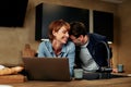 Couple laughing while using a laptop Royalty Free Stock Photo