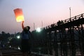 A couple launching light lantern in evening