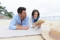 couple lay on beach reading book Royalty Free Stock Photo