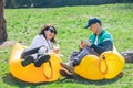 couple laying on inflatable mattress in city park at sunny day. talking and chatting