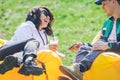 couple laying on inflatable mattress in city park at sunny day. talking and chatting