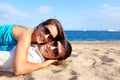 Couple laying together on beach.