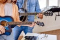 Couple Learning to play the guitar. Male teacher explains to female student Royalty Free Stock Photo