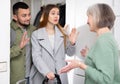 Couple saying goodbye to senior woman