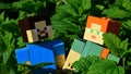 Couple of LEGO Minecraft large figures of Steve and Alex in dense green foliage of Lemon Balm and Spearmint plants.