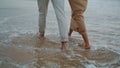 Couple legs crossing seashore at summer closeup. Tender spouses enjoying ocean Royalty Free Stock Photo