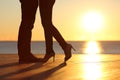 Couple legs falling in love hugging at sunset