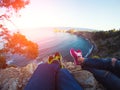 Couple legs hanging over rocks