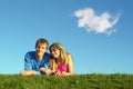 Couple lies on meadow with cloud Royalty Free Stock Photo