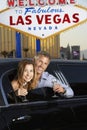 Couple In Limousine With Champagne Flutes By Welcome To Las Vegas Sign Royalty Free Stock Photo