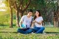 Couple listening music from mobile with headphone in the park Royalty Free Stock Photo