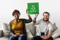 Couple listening to music and holding signs