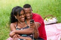 Couple Listening To Music And Watching Video On Mobile Phone Royalty Free Stock Photo