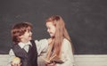 Couple of little girl and boy in classroom. Back to school. Cheerful smiling child at the blackboard. Education. Teacher Royalty Free Stock Photo